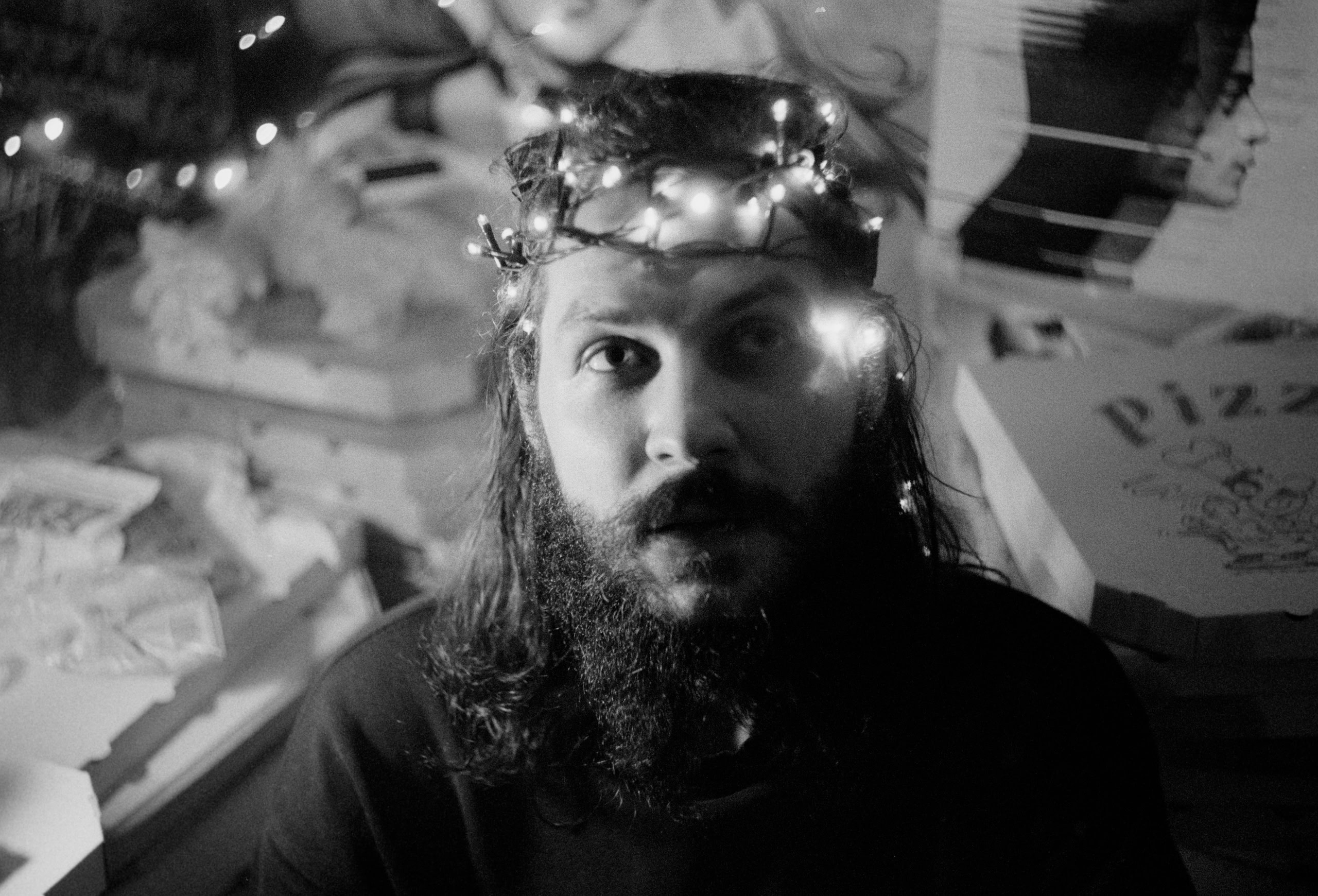 A man with Christmas lights around his head