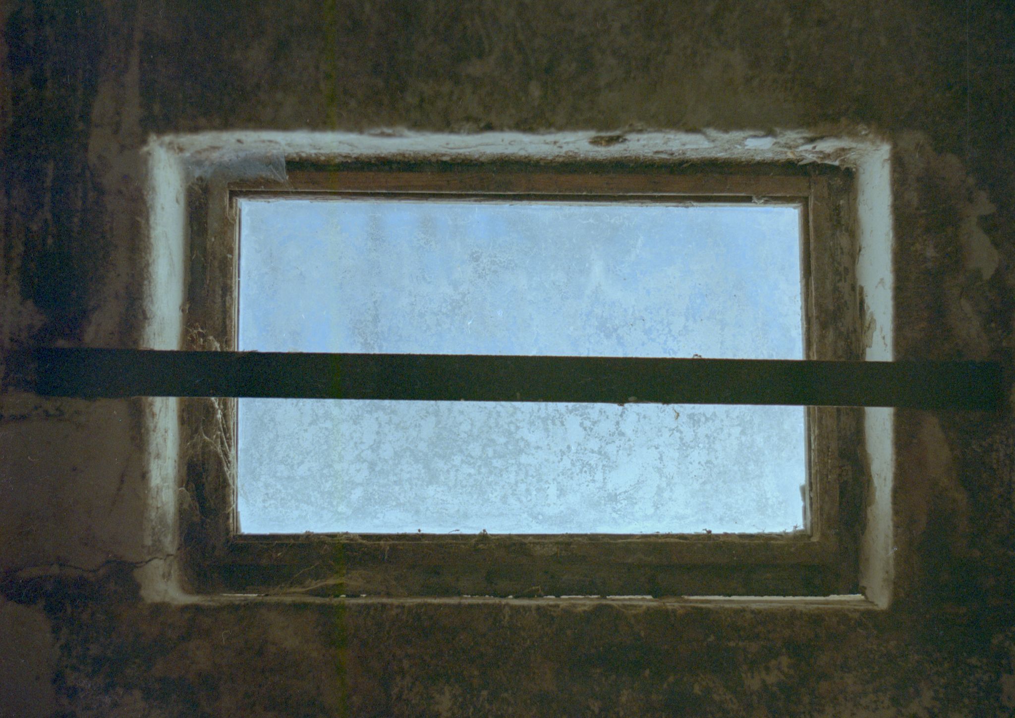 A window in a ruined collective farm with hangings